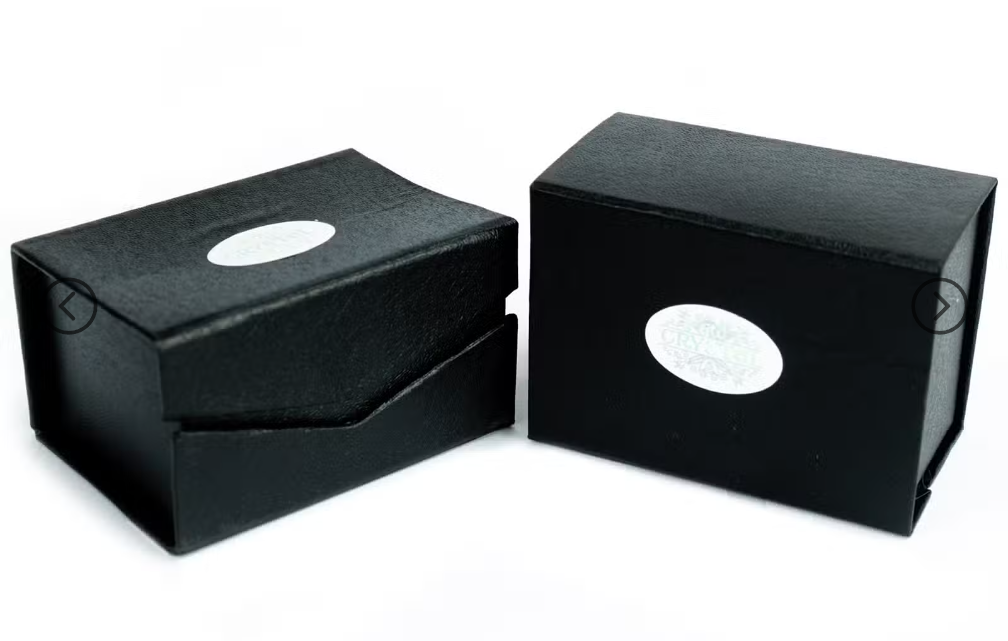 Two black textured gift boxes with oval silver cutouts, shown on a plain white background.