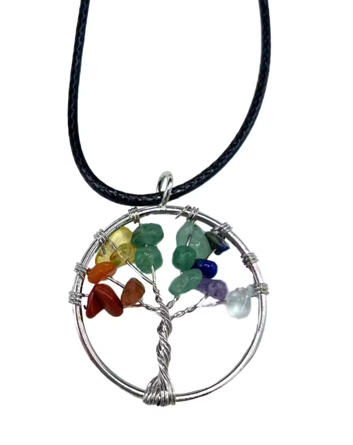 A tree of life pendant necklace featuring seven colorful gemstone chips in a circular silver wire frame, suspended from a black cord, shown against a plain white background.