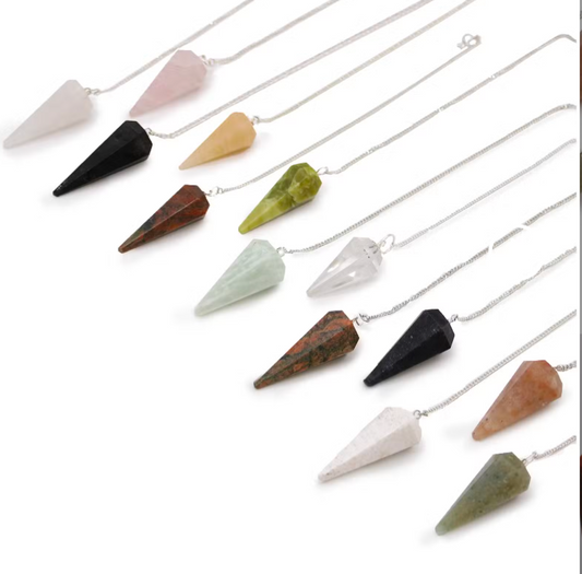 A set of ten crystal point pendulums on silver chains, arranged diagonally on a white background. The pendulums are made of various colored stones including pink, black, yellow, green, brown, and orange.