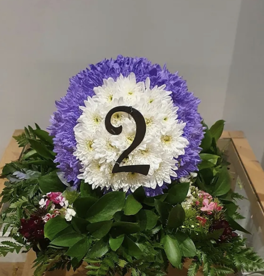 Personalised fresh floral number tribute with purple and white flowers and greenery