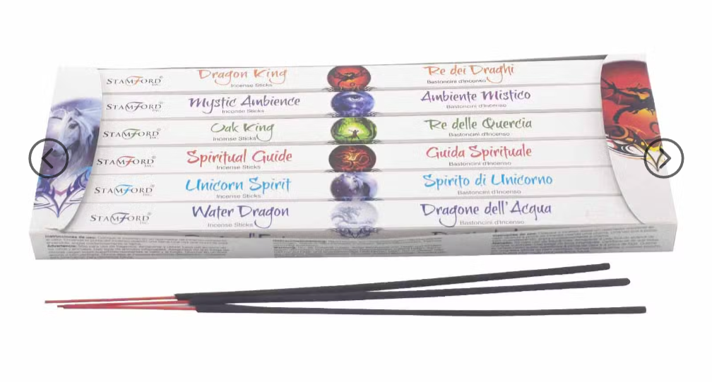 A boxed set of incense sticks on a plain white background. The package is white with multicolored text and illustrations, and several incense sticks are placed in front.