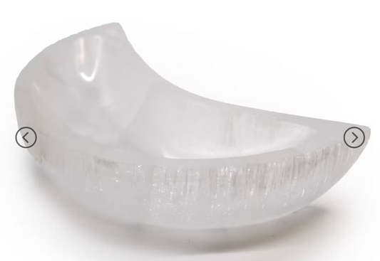 A translucent frosted glass bowl with a curved crescent shape, shown on a plain white background with subtle shadowing. The image has small navigation arrows overlaid on the left and right sides.