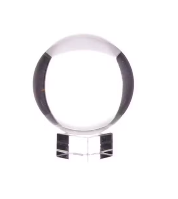 A clear glass crystal sphere on a matching clear acrylic stand, photographed against a solid white background.