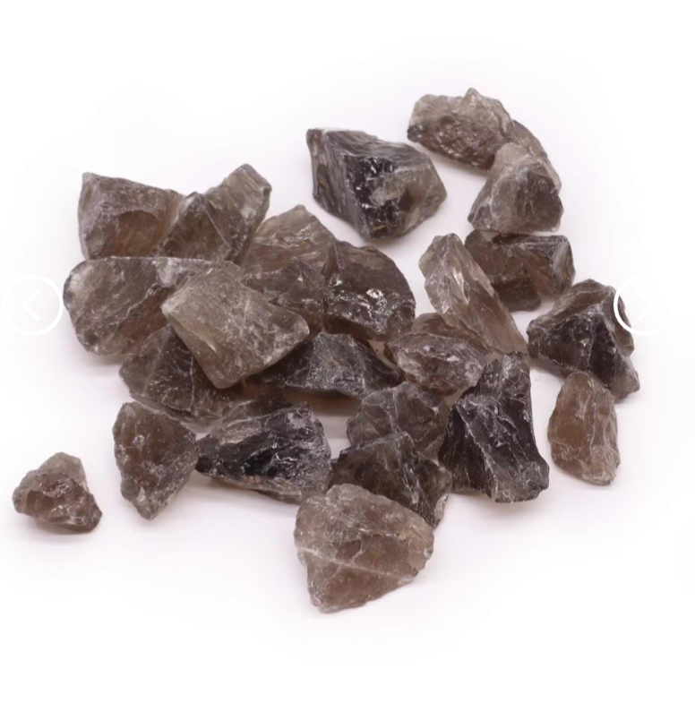 A pile of rough, unpolished smoky brown crystal stones on a plain white background.