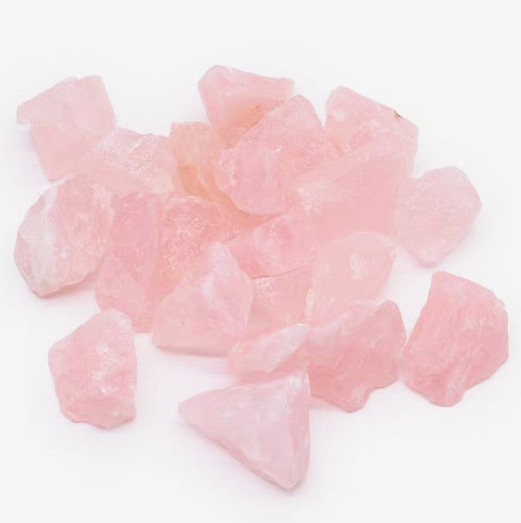 Raw Rose Quartz crystals showing natural pink colouring and unique shapes